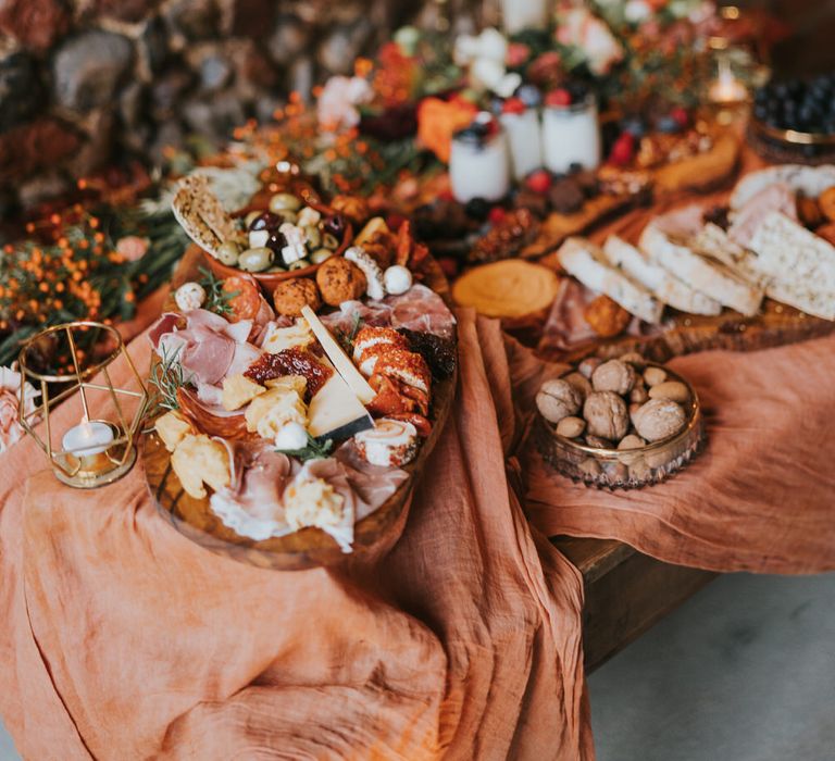 Huge grazing table of food with linen material decor for pumpkin spice wedding