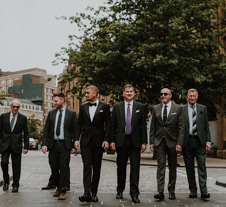 Groomsmen walking through the streets of Sheffield 