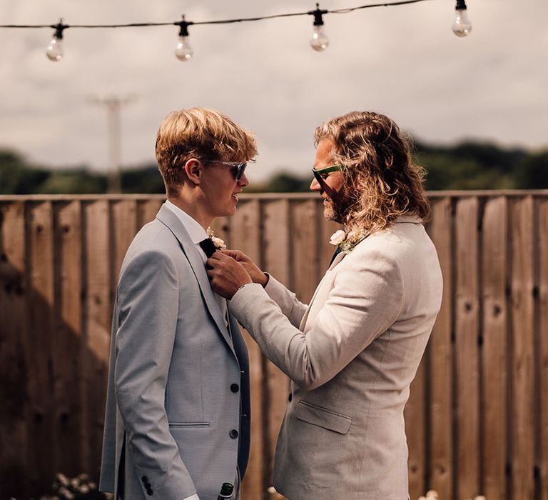 Groom fixing groomsmen's tie 