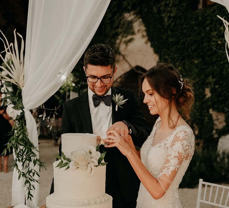 Bride & groom cut their wedding cake outdoors on their wedding day | Royal Studio