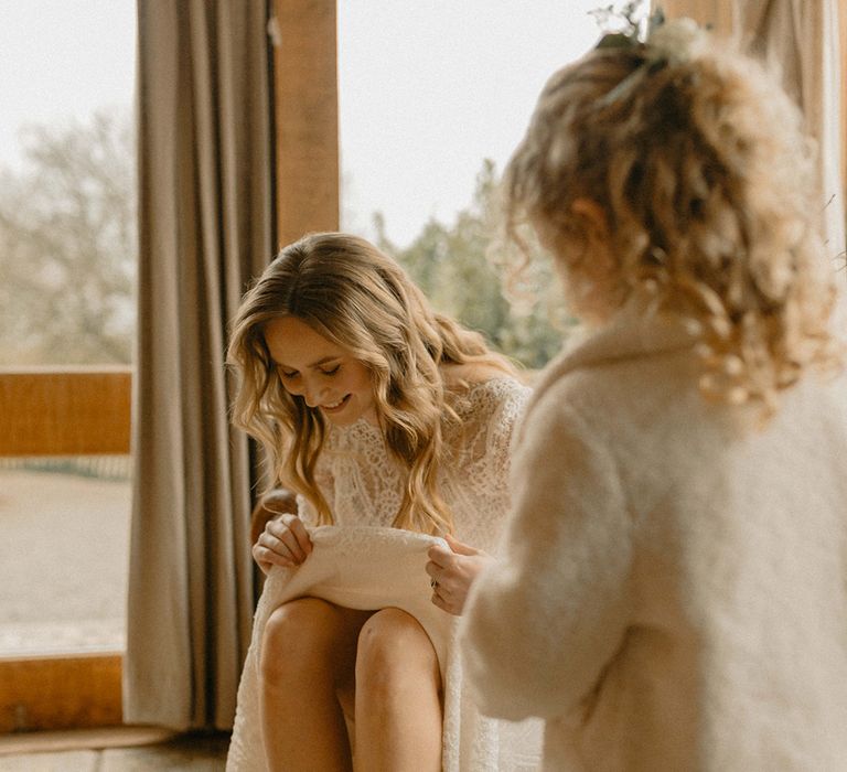 Bride's gold metallic wedding boots with flower girl in white fur jacket 