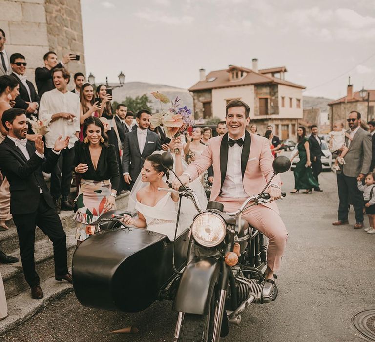 Black wedding motorbike with side car, groom in light pink suit and bride in Bardot style wedding dress 