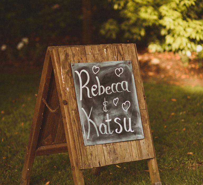 Chalkboard wedding sign with the couple's names written in chalk