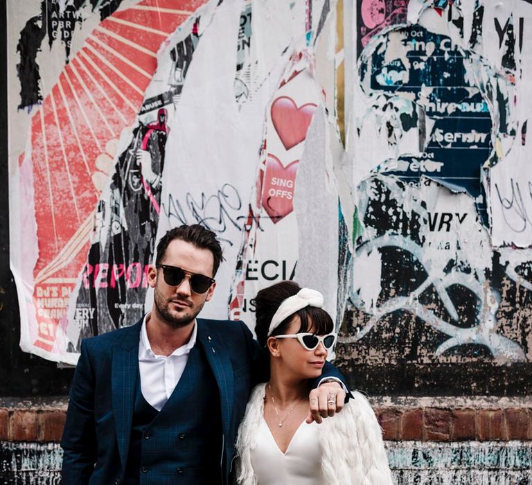 Liverpool micro wedding with bride in, trousers, top, cape, headband and retro sunglasses 