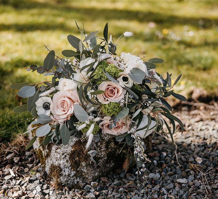 Pink rose, eucalyptus and white flower bouquet for the bride 