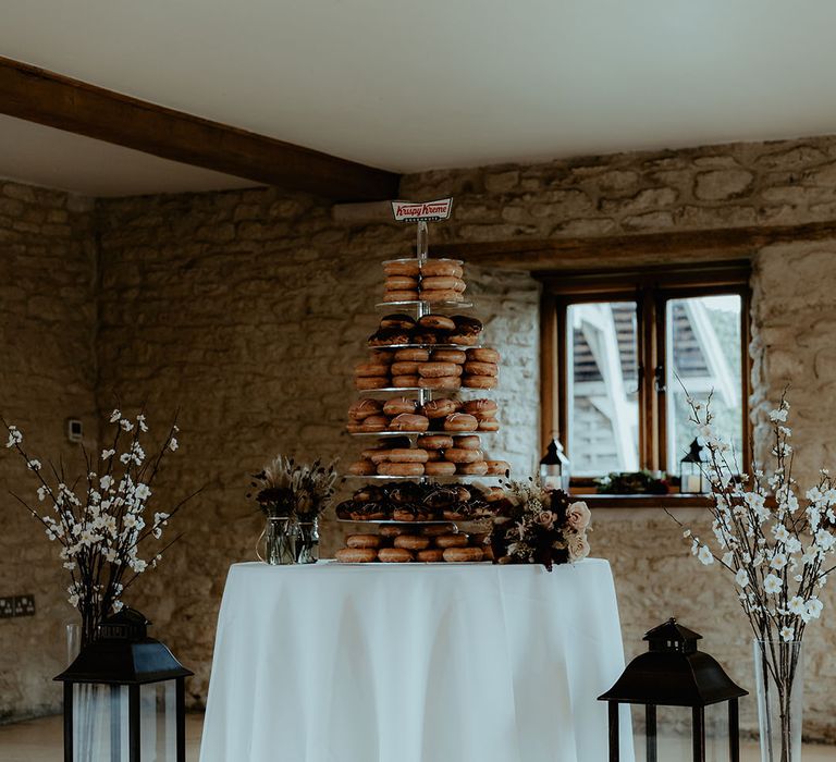 Krispy Kreme doughnut tower alternative to a wedding cake on a white table 