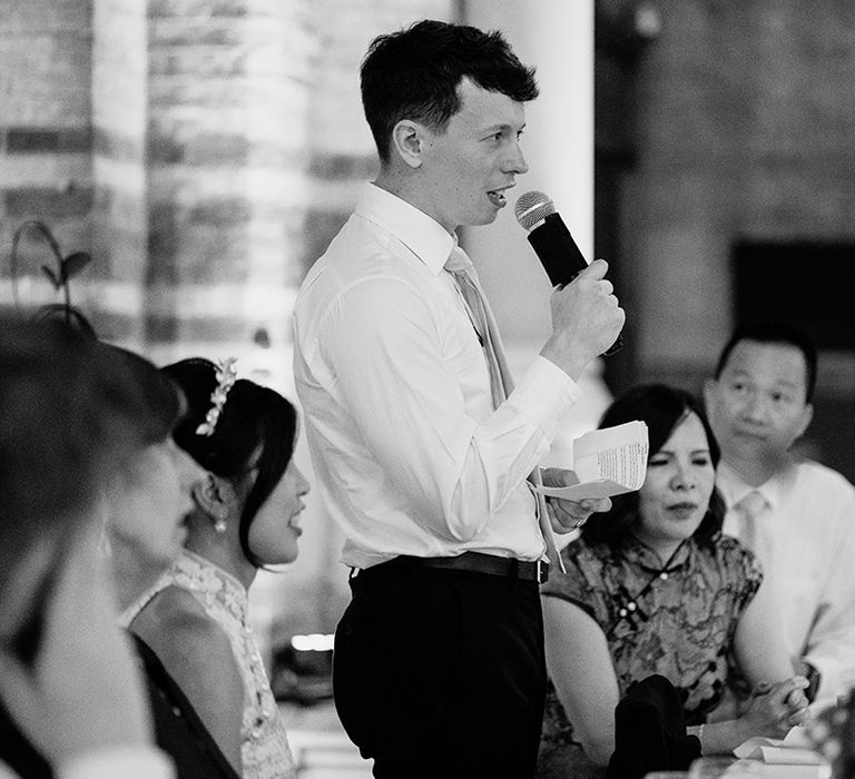 Groom gives wedding speech during reception at St Stephen's church in Hampstead