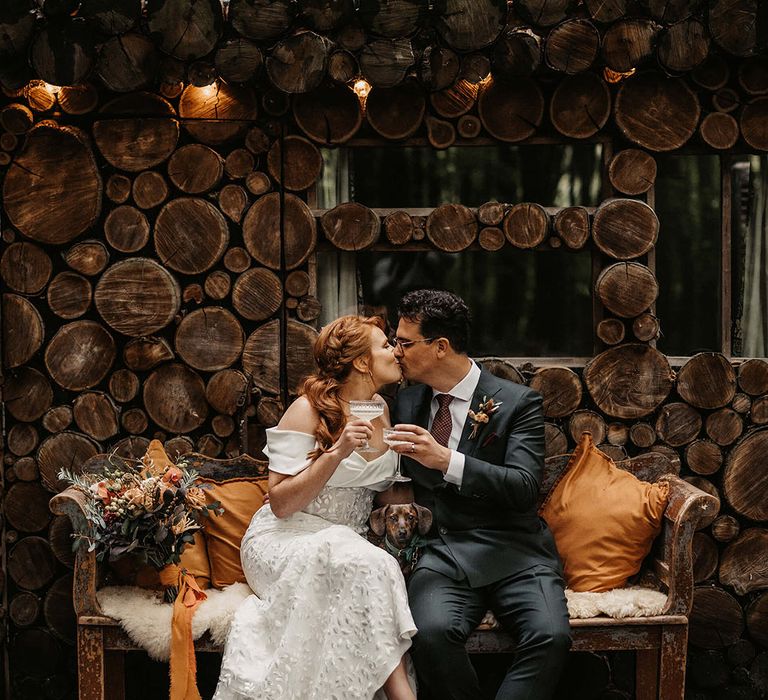 Bride wears Esska Shoes and sits beside her groom in Suit Supply bespoke suit