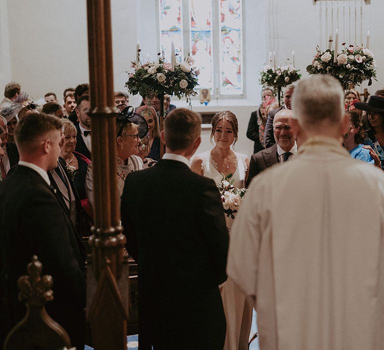 Bride becomes emotional as she sees her groom for the first time during church wedding ceremony 