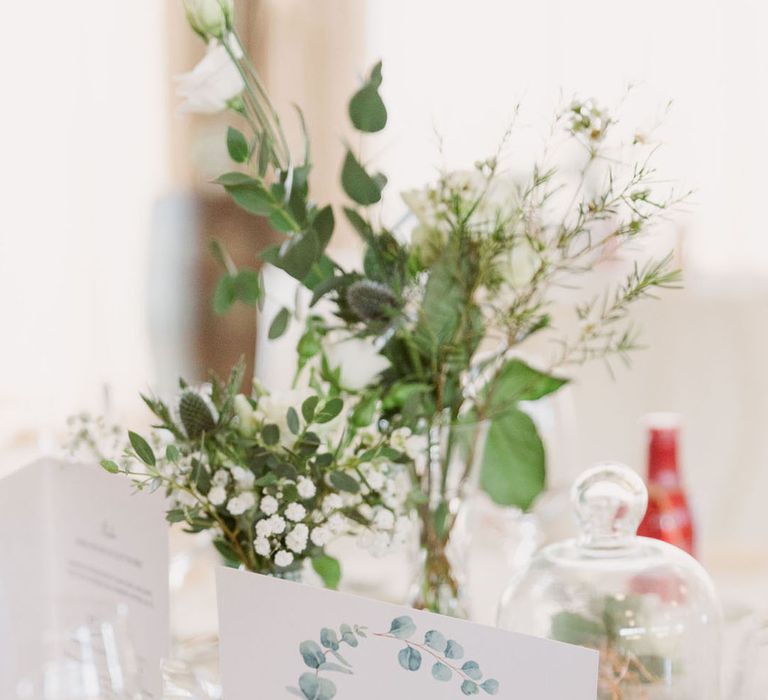 Simple classic and rustic wood tree slice decoration on the table with white table name sign with leaf design 