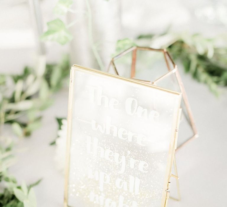 Bright white glittery table signage named in the style of the episodes of Friends the TV show