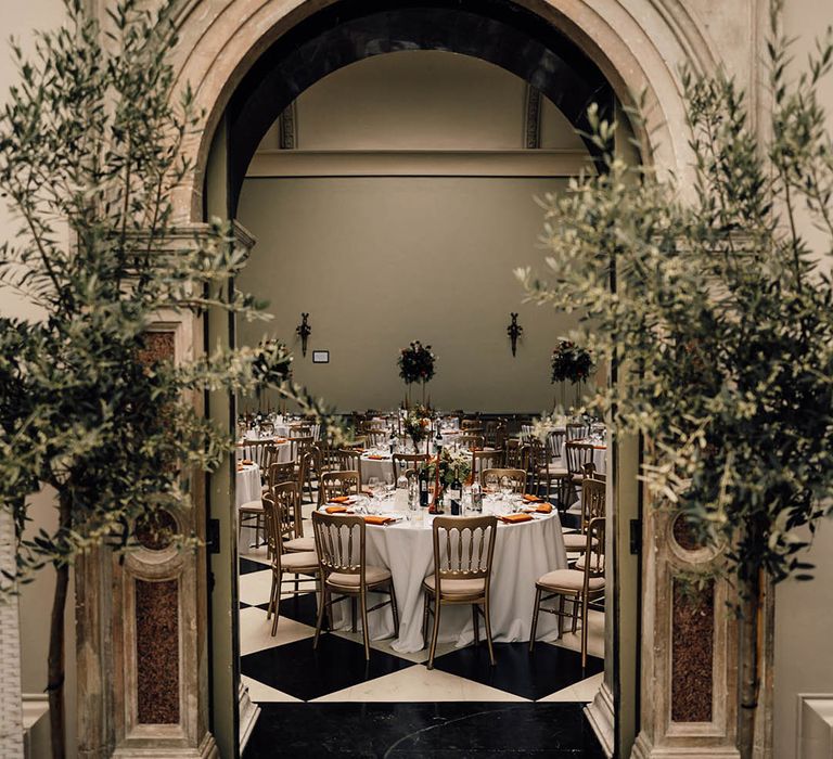 Luxury Hampton Court House wedding venue for traditional wedding with orange table decor and centrepieces 