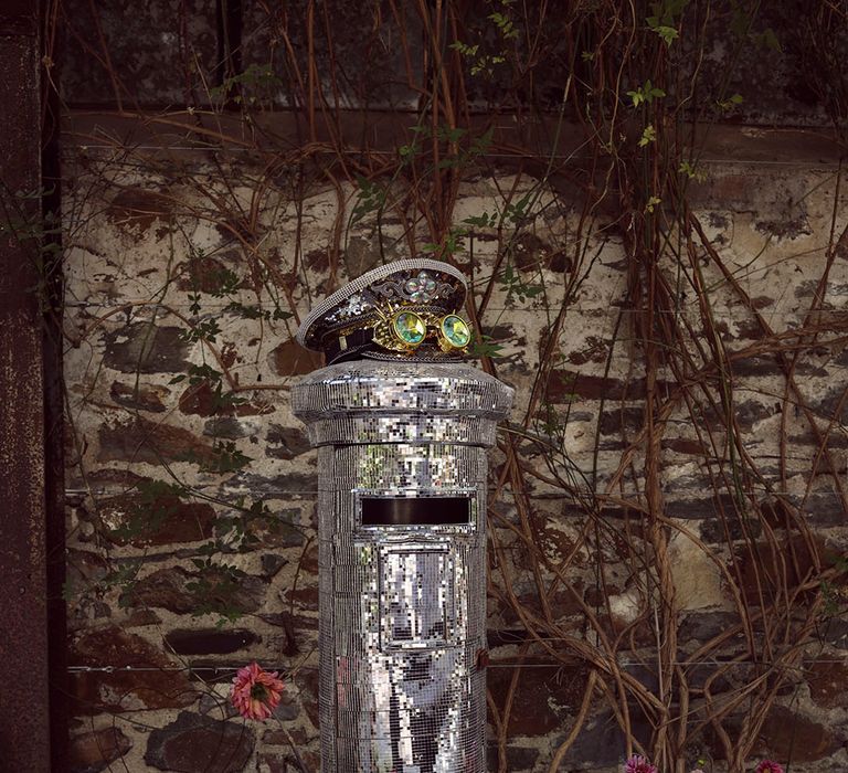 Sparkly disco wedding with DIY mirrorball post box next to the guest book for guest cards 