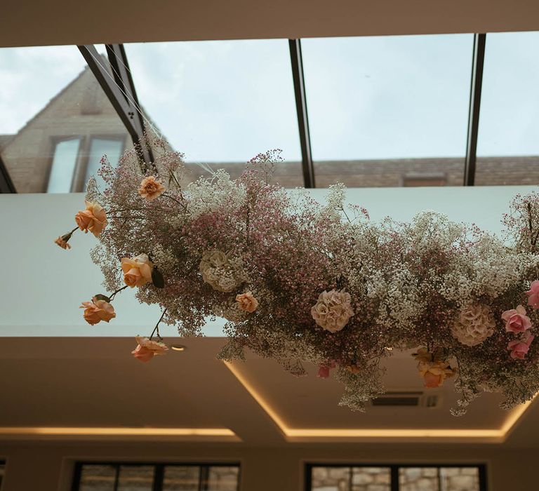 hanging pink and yellow roses, hydrangeas and gypsophila flower cloud 