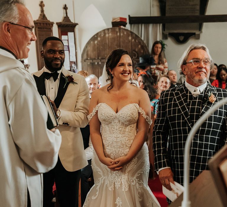 Bride in Martina Liana sweetheart mermaid wedding dress with groom in white tuxedo 