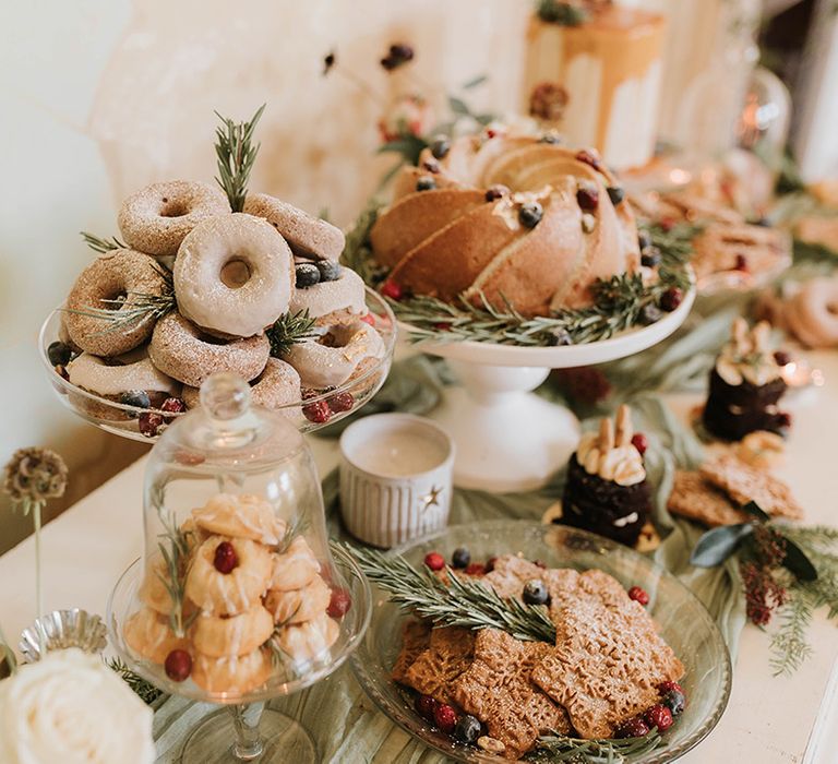 Wedding dessert table with winter festive treats and food 