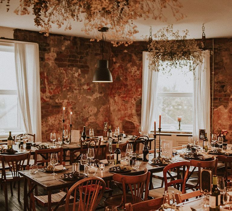 The wedding breakfast tablescapes at the rustic industrial wedding venue with autumnal styling and spooky decor 