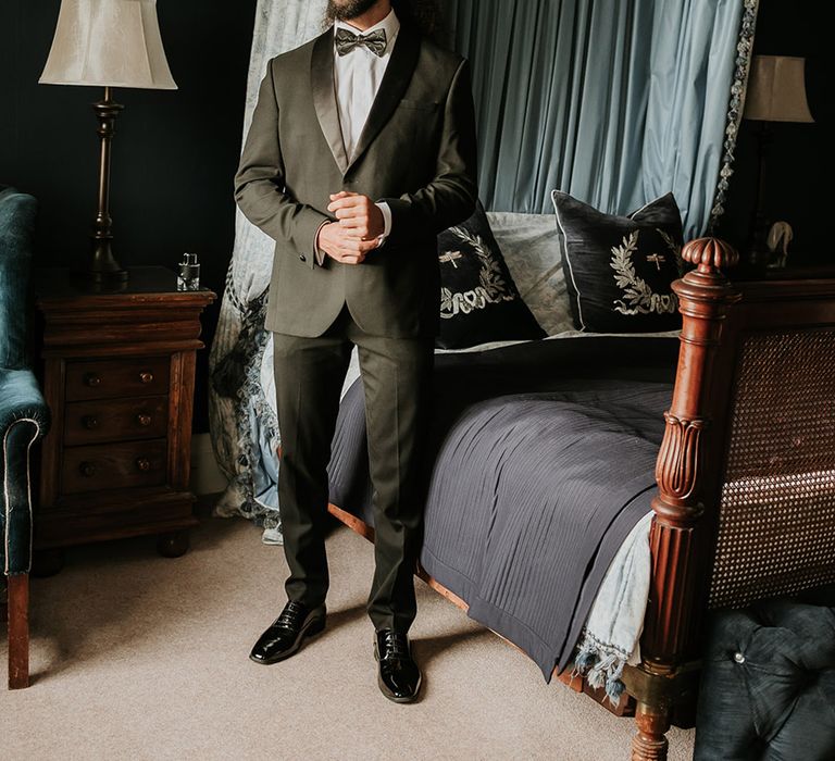 Groom in black tuxedo getting ready for the wedding 