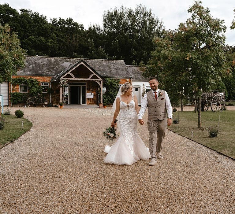 Bride and groom pose for their couple portraits together at boho wedding 