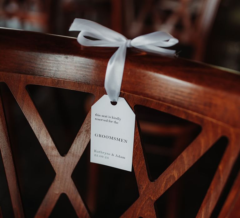 Minimalist wedding chair tag that reserves the chairs for certain guests 