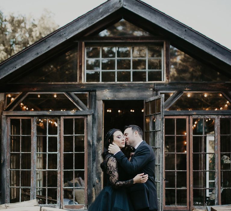 Foxfire Mountain House with bride and groom in black wedding outfits for spiritual wedding 