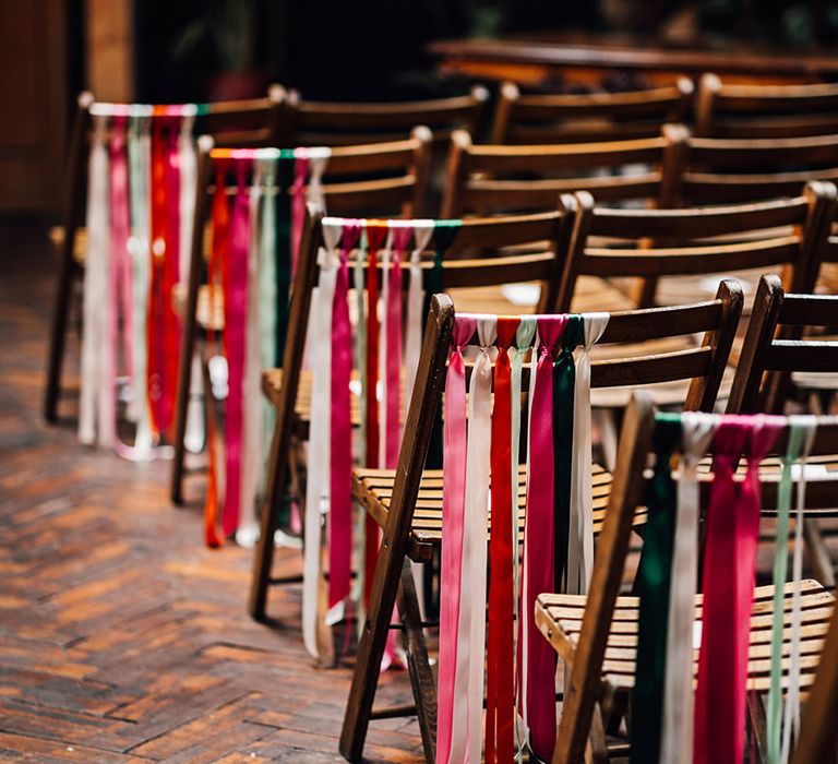 Colourful ribbons decorarting the wedding chairs for eccentric wedding 