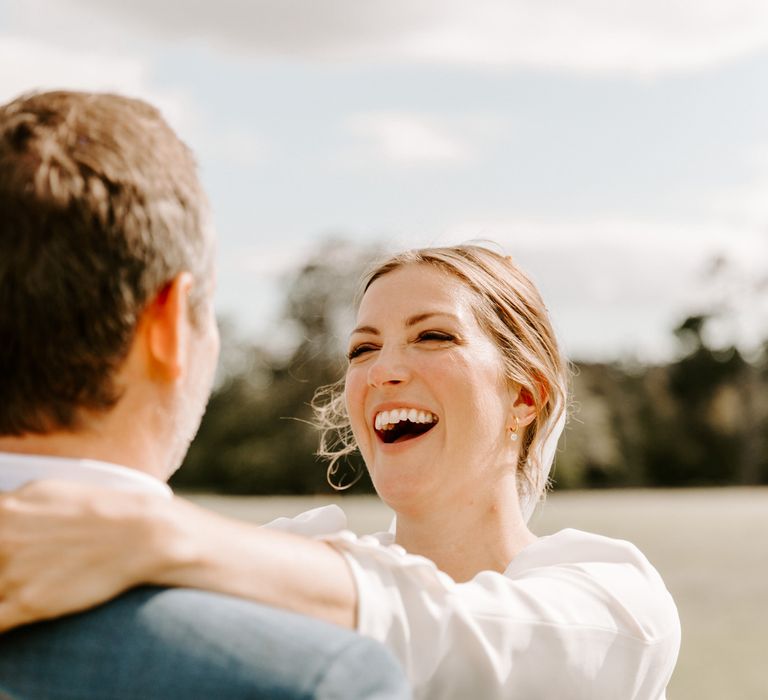 Bride smiles at groom as they enjoy their micro wedding