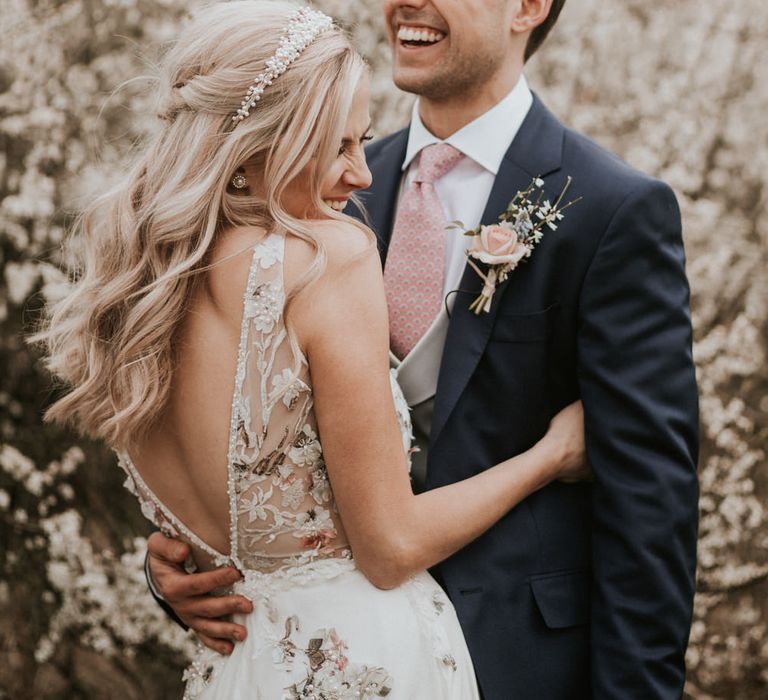 Bride in floral embroidered wedding dress and pearl headdress