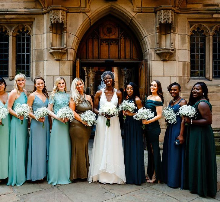 Bridal party portrait with bridesmaids in green ombre dresses 