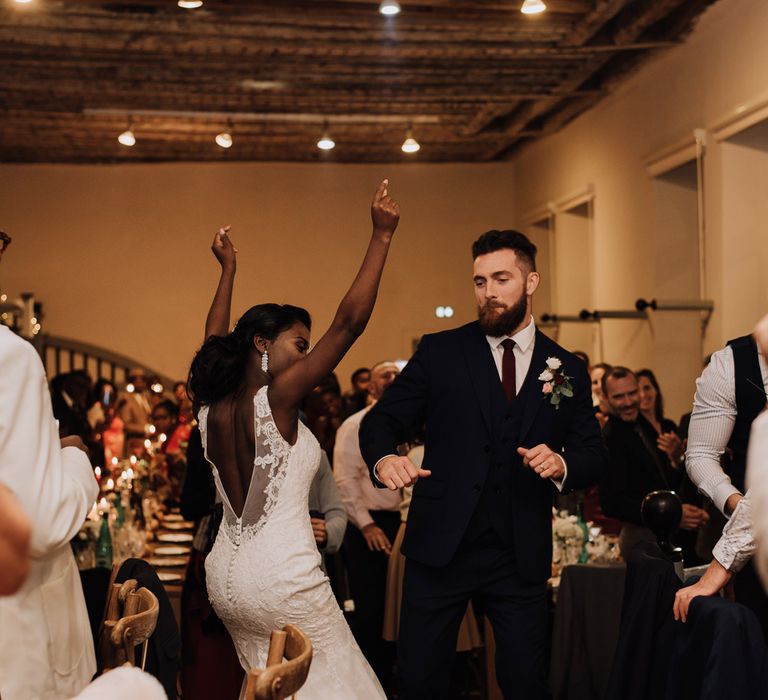 Bride and groom dancing at their candle lit wedding reception 