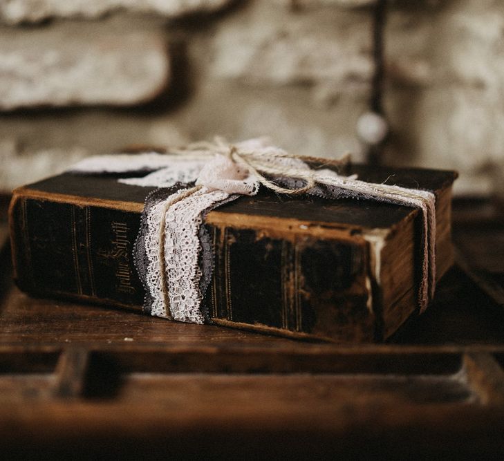 Old leather book with lace wrapped in a bow on the outside