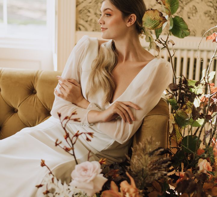 Bride wears sheer long sleeve wedding dress with button cuff details