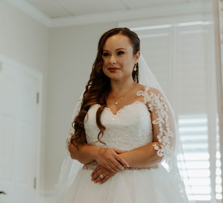 Bride in strapless wedding dress with embellished bodice and tulle skirt on her wedding morning 