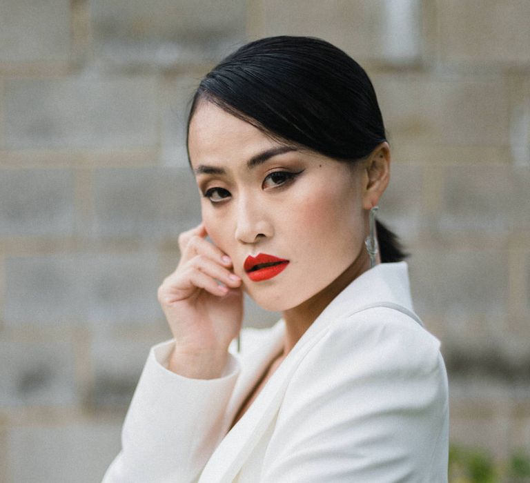 Sleek white bridal suit for a high-fashion bride