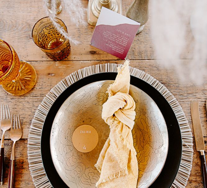 Table decor complete with brass candlestick holders and brass cutlery 