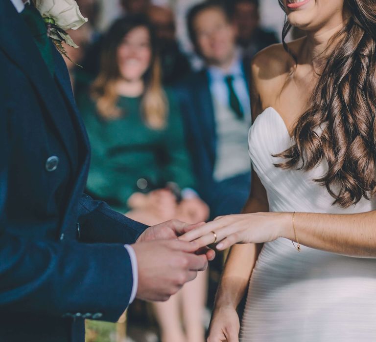 Bride and groom exchanging rings