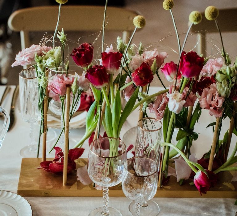 White plates, white napkins, gold cutlery and gold menus for a vintage themed micro wedding