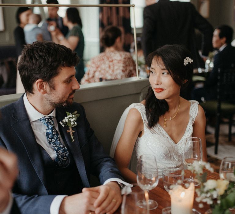 The bride and groom sat at their pub wedding reception