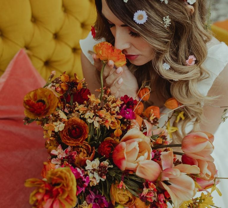 Bride in stunning flower crown holding large bouquet