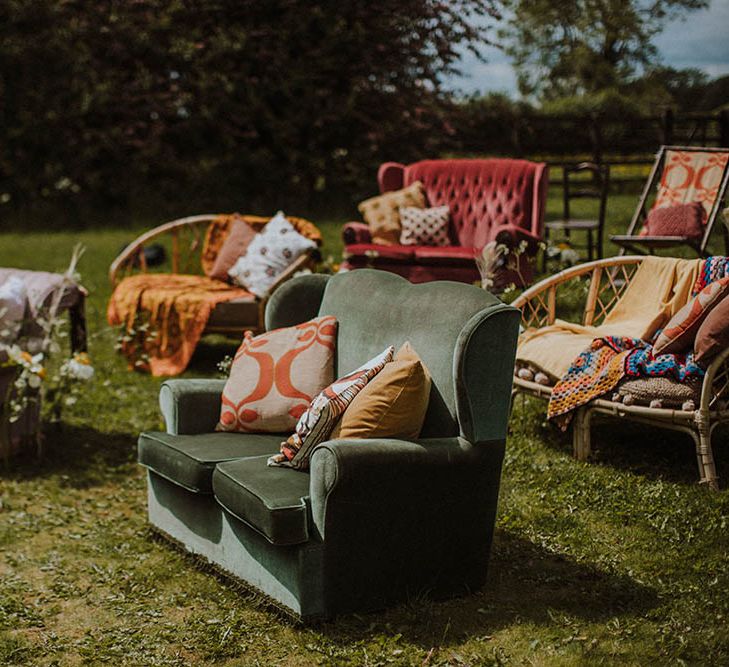 outdoor sixties wedding with retro furniture seating, cushions and rugs 