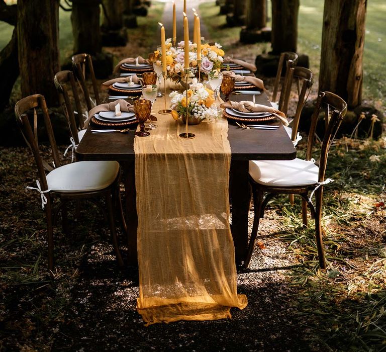 Outdoor reception with gold, brown and honey yellow wedding decor and details 