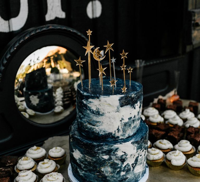 Outdoor Preston Court wedding with a blue and white celestial wedding cake and gold star cake toppers 