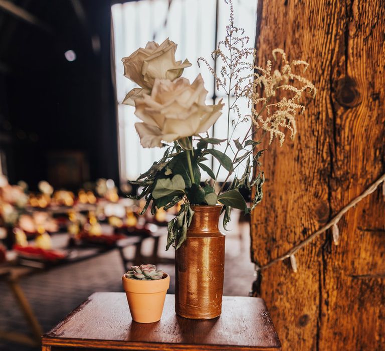 Wooden plagues & pale open roses at Elmley Nature Reserve wedding