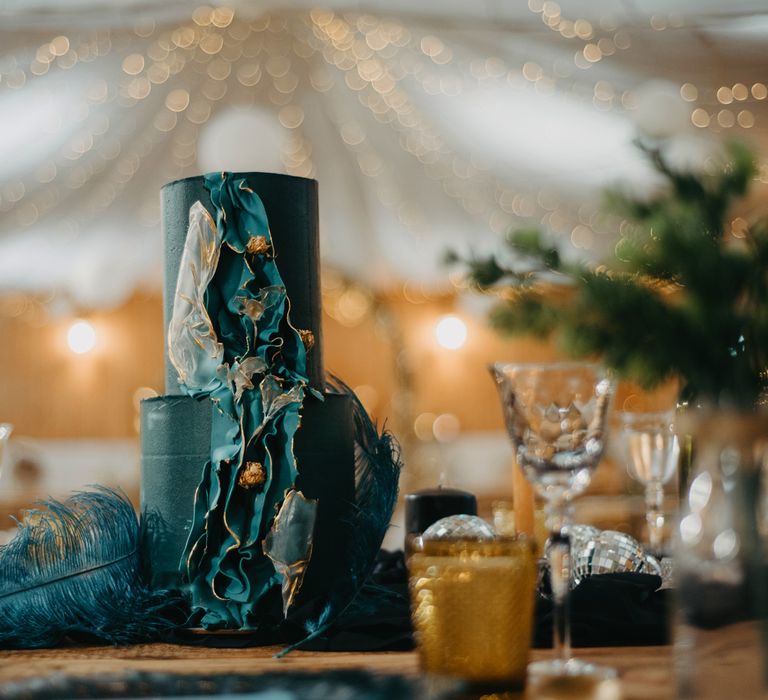 Two tier blue wedding cake with ripple decoration and rustic wedding decor at The Wellbeing Farm wedding in Lancashire