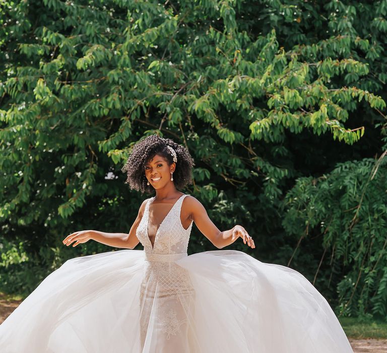 Black bride in a Ersa Atelier wedding dress with tulle skirt and embellished bodice with plunging neckline 