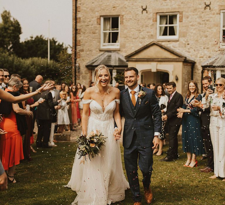 Bride and groom confetti exit at East Afton Farmhouse wedding