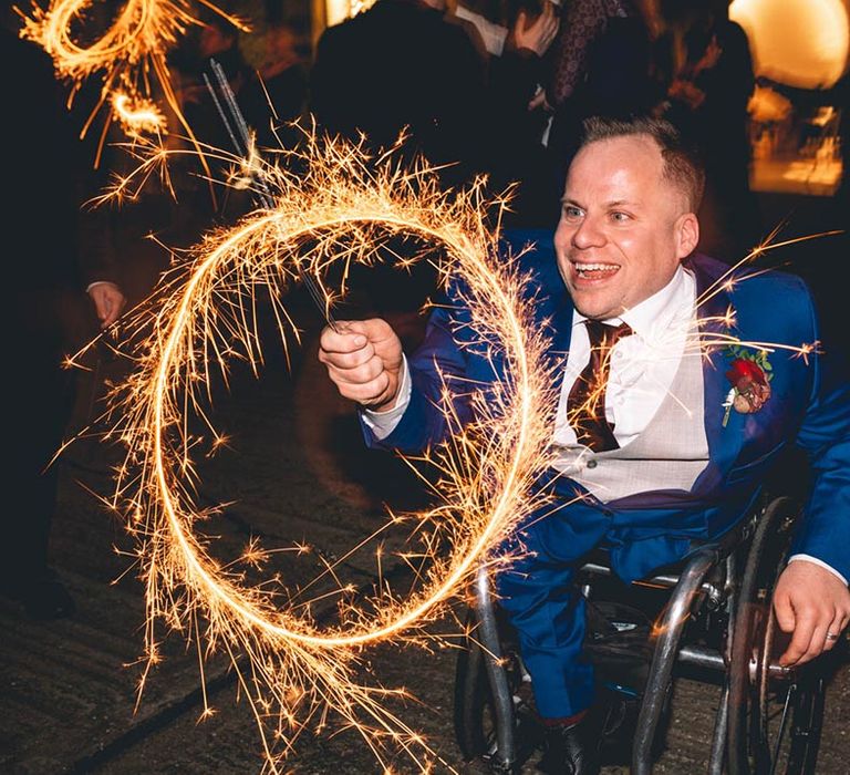 Groom with sparkler at industrial wedding in London