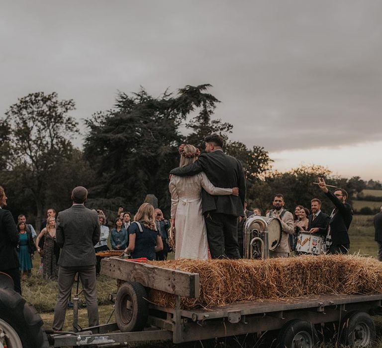 Bride and groom on tractor at wedding