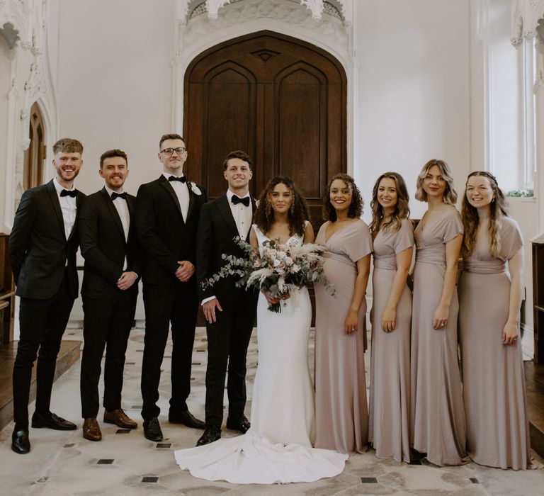 Bride & groom stand with their wedding party