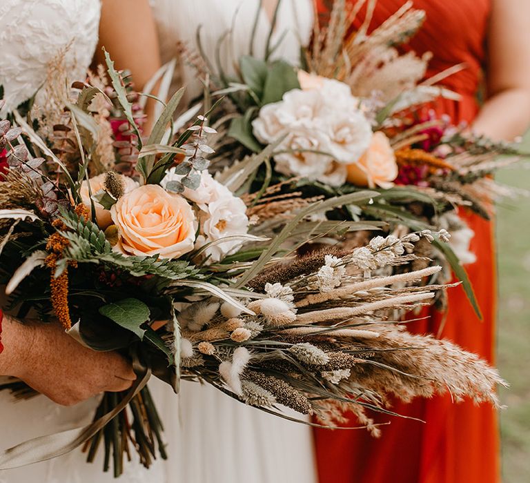 Bride holds Autumnal bouquet filled with pampas grass